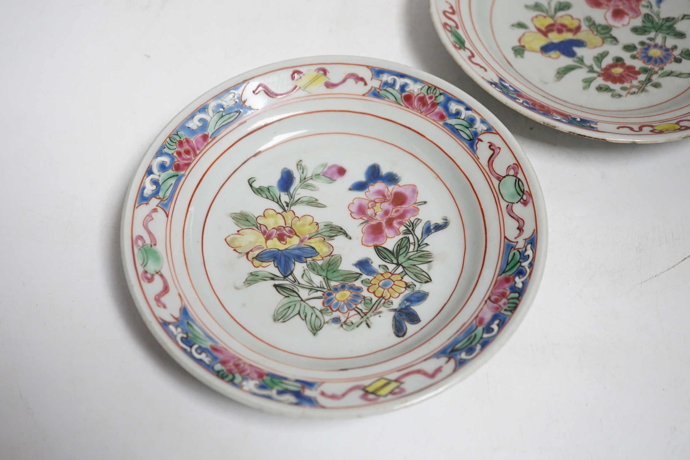 A pair of Chinese famille rose fencai small plates, early Yongzheng period, 16 cms diameter